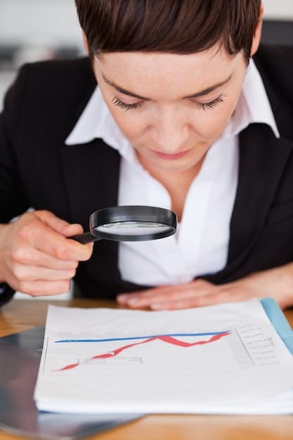 A magnifying glass focusing on a financial report highlighting positive earnings and revenue growth for a company.