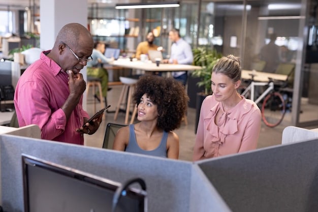 A diverse group of professionals collaborating in a modern, open-plan office. Some are working on laptops, others are discussing ideas on a whiteboard, and a few are engaged in virtual meetings via video conferencing. The scene emphasizes teamwork, technological integration, and the blending of physical and virtual work environments.