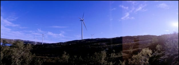 A split image showing a modern, clean energy power plant with solar panels and wind turbines on one side, and a traditional coal-fired power plant with heavy smoke emissions on the other side, illustrating the transition towards cleaner energy sources driven by environmental regulation.