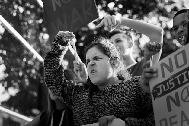 A black-and-white photograph depicting a protest during the Civil Rights Movement juxtaposed with a modern-day protest, symbolizing the continuity of social justice struggles and the ongoing pursuit of equality.
