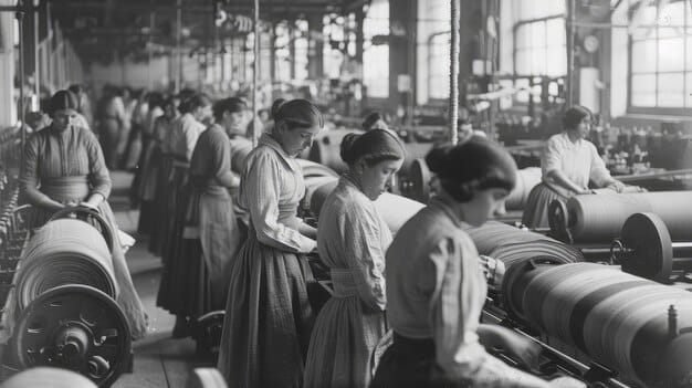A black-and-white photograph depicting industrial workers in a textile mill during the late 19th century in the US. The scene shows crowded conditions with numerous workers operating machinery, highlighting the challenging and often dangerous environment of early industrial labor.