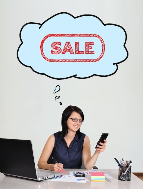 An image showing a person shopping online using a laptop, with a speech bubble above the laptop displaying tips on how to stay informed about sales tax laws.