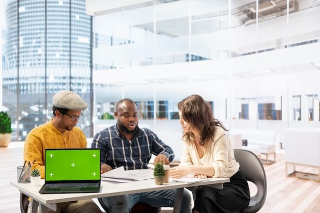 A diverse group of people in an office environment, some looking at computers, some in discussion, symbolizing a healthy and active labor market.
