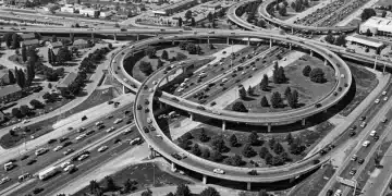 Post-WWII Boom's Impact on US Infrastructure & Connectivity Bustling mid-20th century highway interchange, symbolizing post-WWII US infrastructure growth